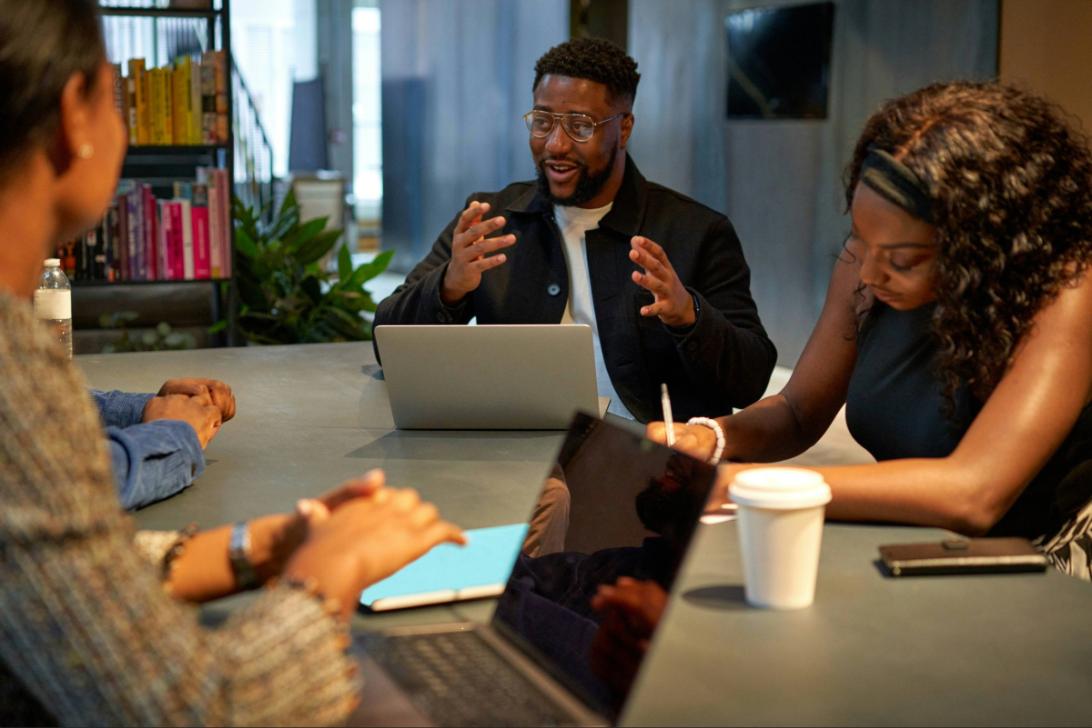 Team discussing a plan around a conference table